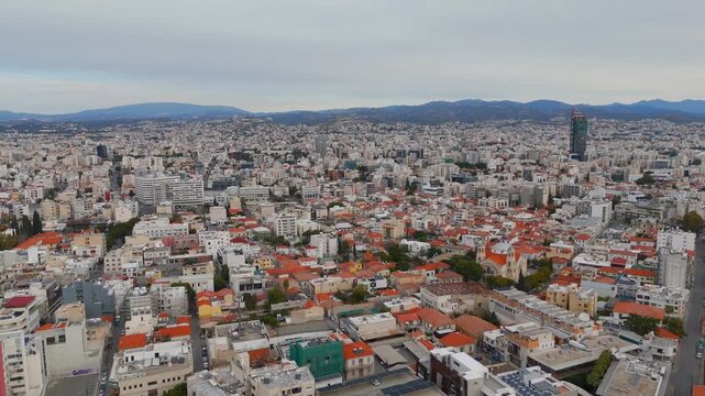 Wide Aerial Drone Pan of Limassol City Skyline Moving Toward Mediterranean Sea Coastline