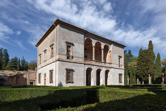 Renaissance summer pavilion (Casina del Piacere) at Villa Farnese in Caprarola, Italy. Historic stone building with loggias surrounded by manicured hedges.
