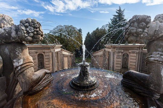 Close-up of stone sculptures and water jets at the Fountain of the Giants in Villa Farnese, Caprarola. Scenic garden view with Italian Renaissance architecture.