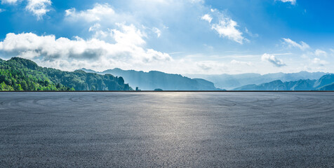 Naklejka premium Empty asphalt road and scenic mountain landscape under a blue sky with white clouds, Hunan, China