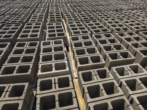 Rows of stacked concrete blocks in outdoor industrial setting