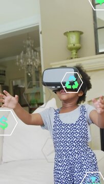 Vertical video: Kid with VR headset on couch reaching, icons tracking hands and exploring education
