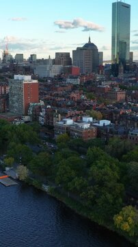 Vertical drone shot of Boston's historic brownstone homes and modern skyscrapers