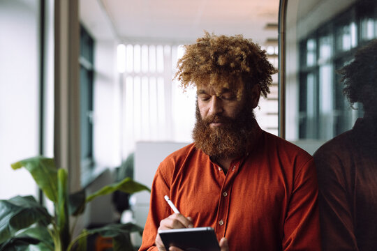 Businessman using tablet PC with digitized pen in office