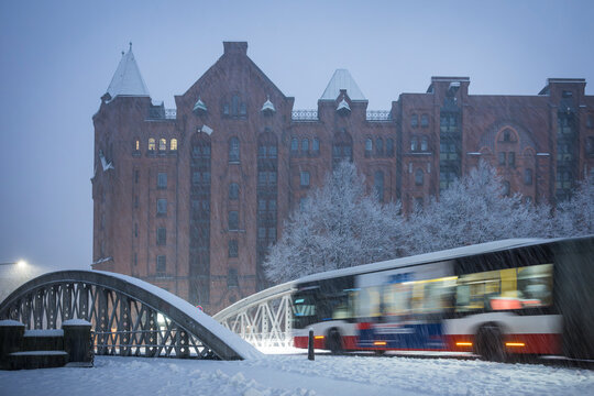 Bus driving over a bridge in snowy Hamburg Speicherstadt