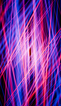 Abstract colorful laser lines glowing in dark background
