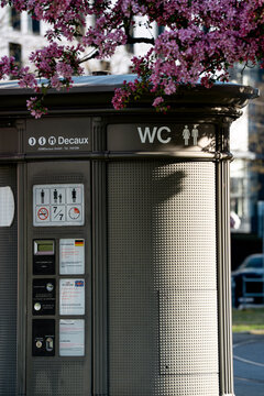 20 April 2026 - Moosach Munich - Public Toilet Cabin Spring Cherry Blossoms - Modern Urban Street Furniture Bavarian Infrastructure Germany