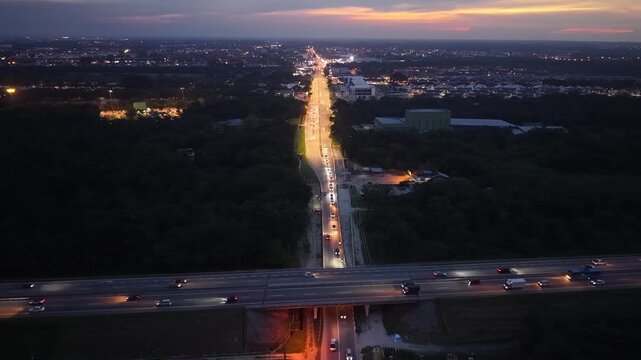 Drone aerial shows car traffic on a Jawi road and highway at night in Penang.