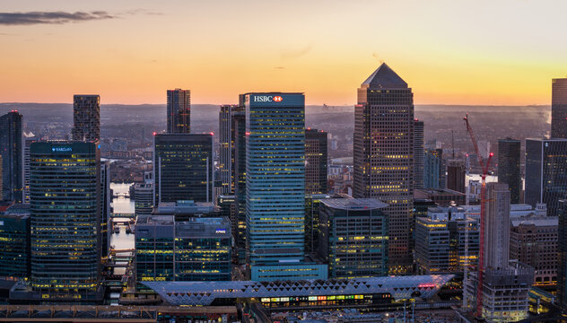 London, England - January 4th 2026: panoramic aerial cloe-up view of the financial office skyscrapers at Canary Wharf during sunset time