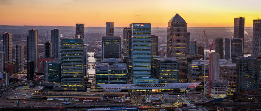 London, England - January 4th 2026: panoramic aerial cloe-up view of the financial office skyscrapers at Canary Wharf during sunset time