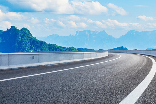 Curved asphalt highway winding through mountain landscape in Zhangjiajie, China