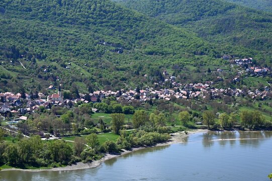 the riverbend of the Danube river at Domos village, across from Nagymaros, Hungary. lush green hills in background. popular summer holiday destination. . smooth, calm water surface. sandy beach