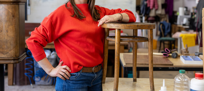 Female Carpenter Standing in her Workshop
