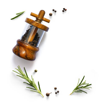 Wooden pepper mill with rosemary sprigs and black peppercorns isolated on transparent background with photorealistic transparent shadow