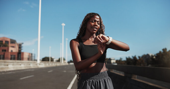 City, runner and black woman with smart watch for exercise, health app and fitness tracker in street. Sports, space and person check time for training, workout progress and active hobby in town