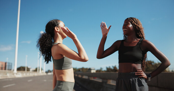 Fitness, women or happy with high five in city for race challenge, marathon pace target or goals. Active, friends or runners with celebration on bridge for cardio success, health progress or wellness