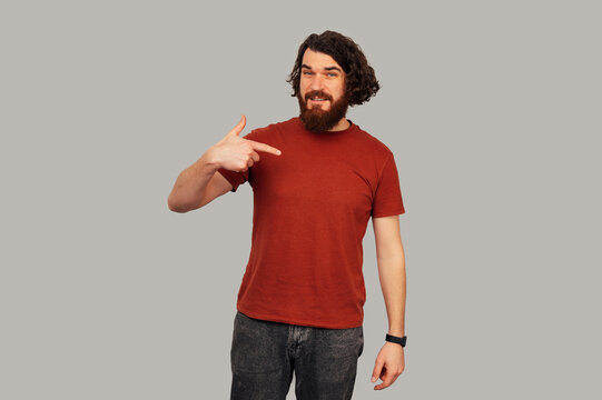 Caucasian Man Pointing To Right Side, Bearded Casual Endorser In Red Shirt With Confident Expression