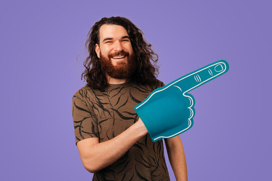 Caucasian Man Pointing At Oversized Graphic Hand, Upbeat Marketer In Patterned Shirt Emphasizing Calltoaction