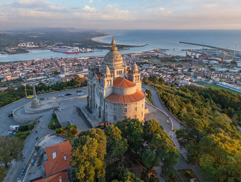 Drone shot of the Basilica of Santa Luzia at the golden hour with the city of Viana do Castelo and the Atlantic Ocean, Portugal.