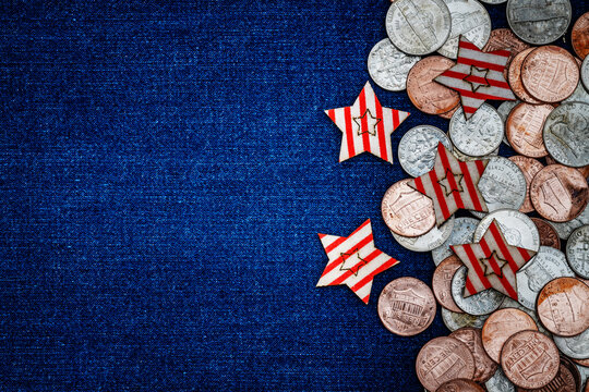 Coins and stars arranged on blue fabric surface during a festive celebration