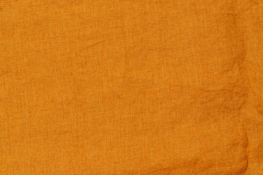 Bright orange fabric laid out on a flat surface in natural light during daytime