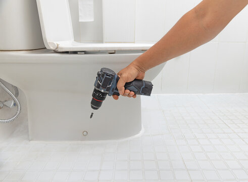 Handyman replace hinge rubber plug and Screws for toilet seat.