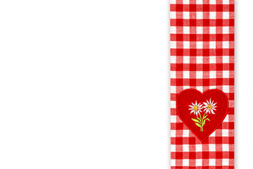 Obraz premium Red checkered fabric with heart design showing floral embroidery in a simple style