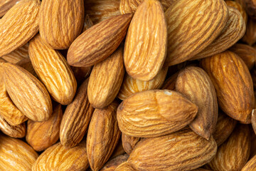 Fototapeta premium Macro shot of Almonds flat lay showcasing their texture