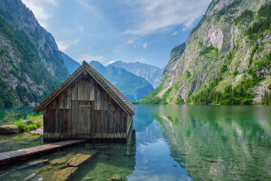 Boat hangar at Obersee mountain lake in Alps Bavaria with clear water, mountain reflections and a centered composition in scenic Germany nature.