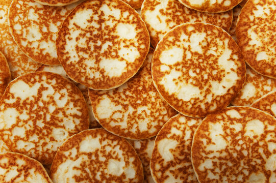 Background and texture of a mountain of pancakes. View from above. Fresh homemade pancakes.