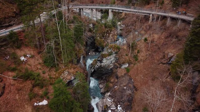 Aerial: Pochtenkessel deep rock funnel with forest near Adelboden, canton of Bern, Switzerland, dolly out drone shot