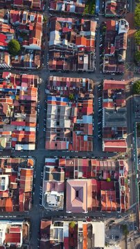 Vertical top-down aerial view of Georgetown's old town in Penang Island, Malaysia. Dense urban grid with colorful rooftops, streets, and historic layout forming a vibrant city pattern. UHD.