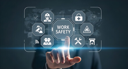 Obraz premium A hand interacts with a futuristic work safety interface displaying various icons.
