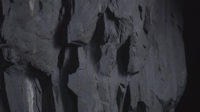 Rough dark grey rock wall texture background