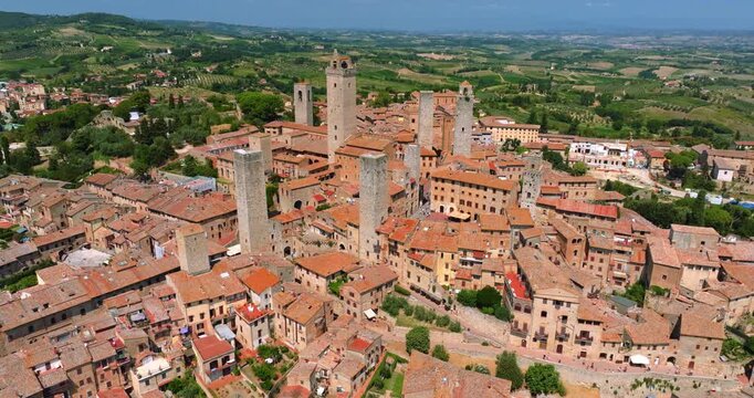San Gimignano Italy aerial view medieval towers. Historic cityscape Tuscany red roofs sunny summer day. Drone shot stone architecture travel destination landmark heritage tourism high angle.