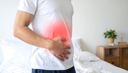 Obraz premium Man experiencing stomach pain at home.