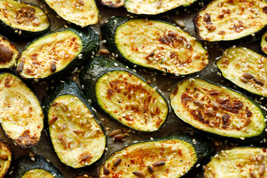 Grilled slices of zucchini with addition aromatic spices and seeds, top view