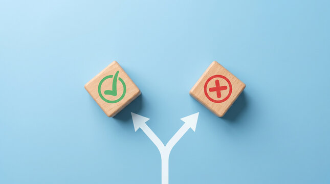 Two wooden cubes on diverging paths with checkmark and X icons, symbolizing critical decision-making choices on a soft blue background.