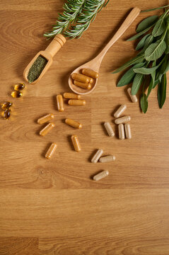 Still life with natural supplements and medicinal plants on a wooden table