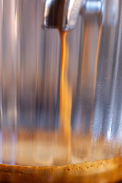 Coffee flows from the portafilter close up