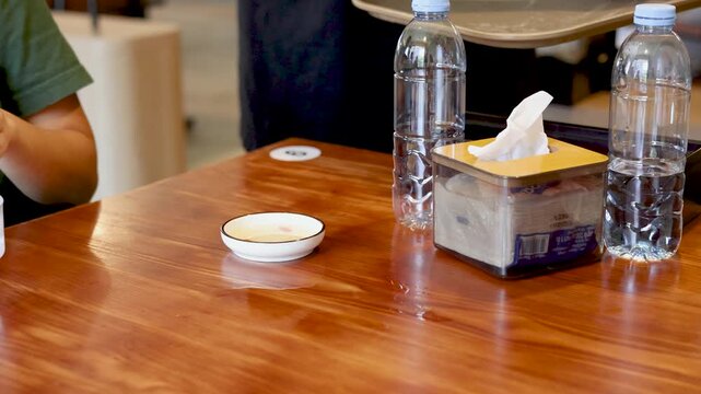 Server Placing Plate of Vietnamese Banh Beo Rice Cakes on Table