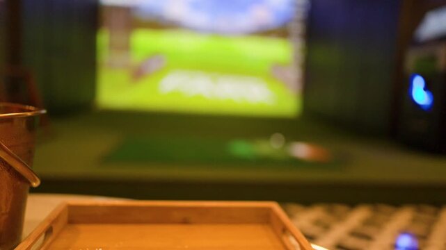 Hand Reaching for Beer Mug at an Indoor Golf Simulator Facility