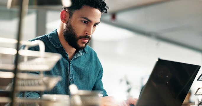 Serious, man and typing on laptop in office for app development, site test or software update. Web designer, person and tech at workplace for problem solving, system maintenance and debugging network