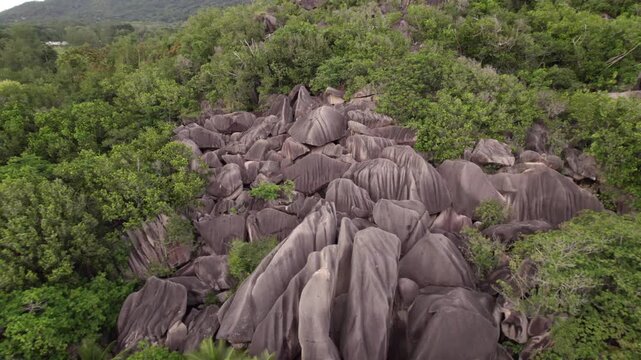 Reveal drone of spectacular low tide beach and granite stone of Anse source d'argent, La Digue, Seychelles 022 30fps
