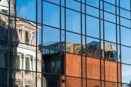 Abstract reflection on modern glass facade of an urban building architecture with windows pattern creating a clean geometric background