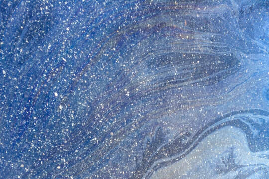 Abstract texture formed by snowflakes on the surface of an icy sidewalk