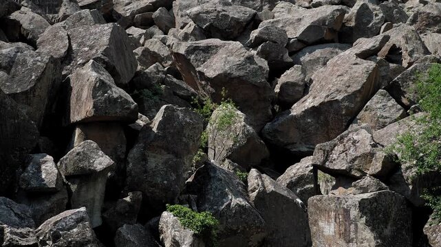 Close-up of a large mountain of stones. The rocks are piled up in a big heap. The collapse of the mountain has left a large pile of rocks.