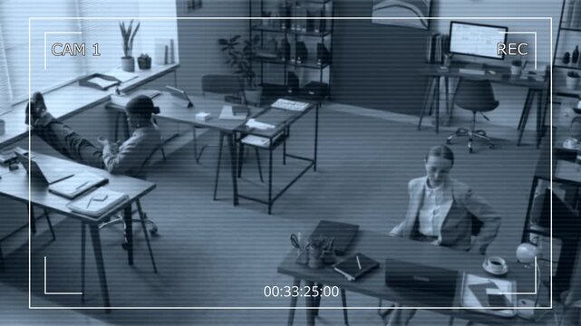 Cam view of African American and Caucasian women working on computers, typing on keyboards, focusing on tasks in open workspace