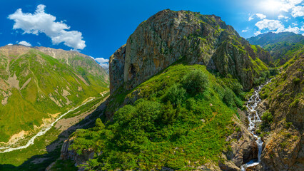 Majestic mountain valley with waterfall and rocky peak © lucky pics