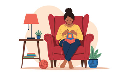 Fototapeta premium Woman sitting comfortably in a large red armchair at home, focused on knitting a colorful woolen garment next to a warm floor lamp.